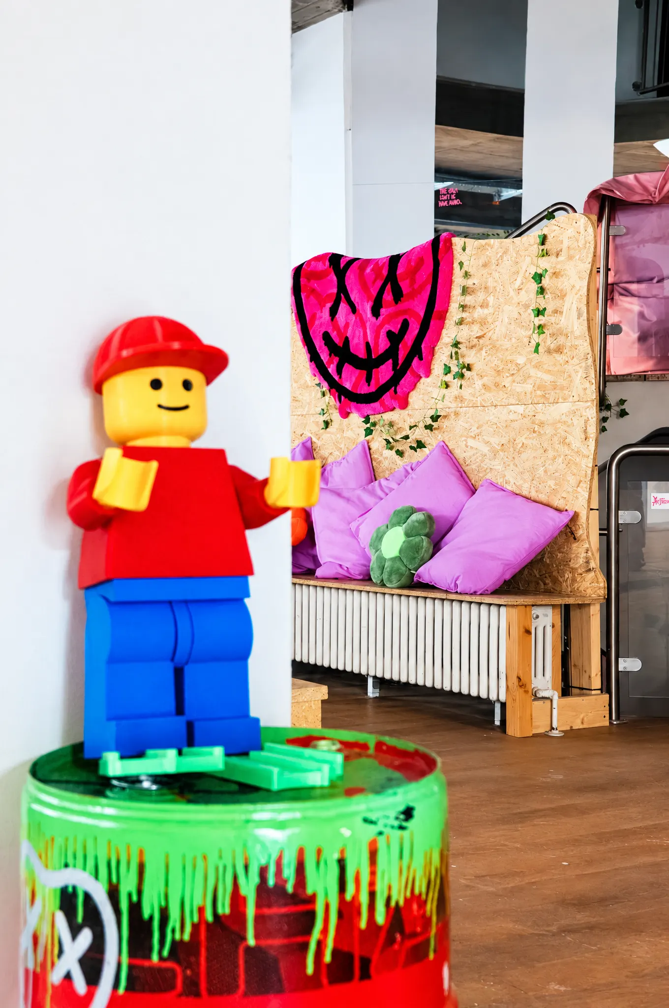Große Lego-Figur auf einem bemalten Farbeimer